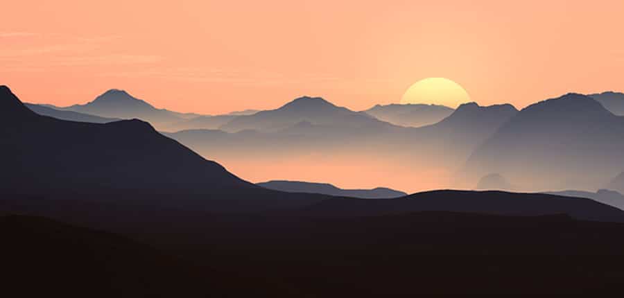 Sun Setting over a mountainous landscape